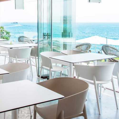 White and pistachio coloured Africa armchairs by Vondom in seaside restaurant.