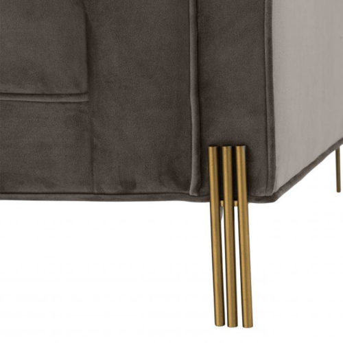 A close up of the Sienna Chair by Eichholtz with polished brass legs.