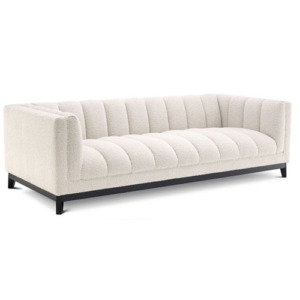 Designer luxurious Sofa Ditmar by Eichholtz available in boucle cream, cambon black and mademoiselle beige upholstery finishes with a black base. Feature deep channel stitching