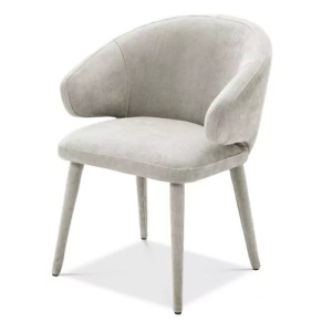 Luxurious Dining Chair Cardinale by Eichholtz available in clarck sand, roche taupe velvet, roche teal blue velvet or clarck grey. Tapered legs feature upholstery covering